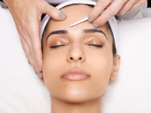 A woman receiving Dermaplaning Facial in Haslett MI at Skin Boss